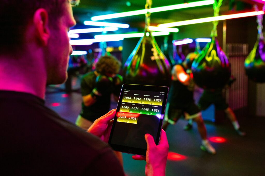 Fitness training in a modern gym with technology for tracking performance on a tablet.